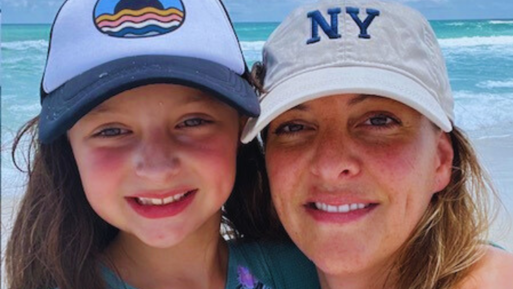 Ms. Cauley pictured with daughter at the beach